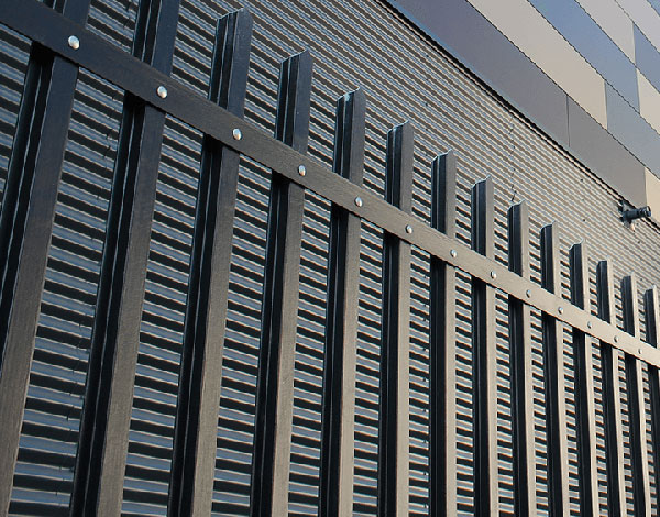 Black GRP palisaid fence surrounding a building