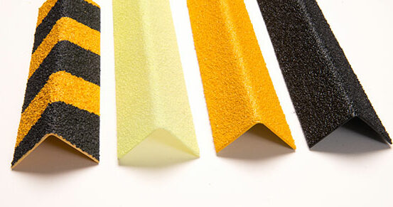 black, yellow, white and a black and yellow anti-slip stair nosings lined up next to each other