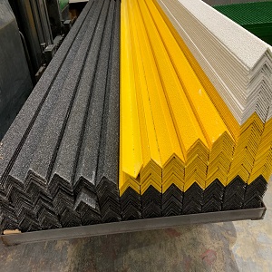 yellow, white and dark grey GRP nosings in stock stacked on top of each
